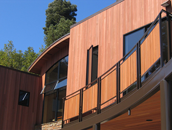 Redwood Tougue and Groove siding applied vertically.